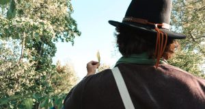 Adam Birchweaver examining a leaf in nature