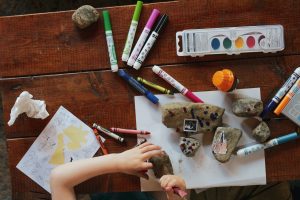 A child painting rocks 