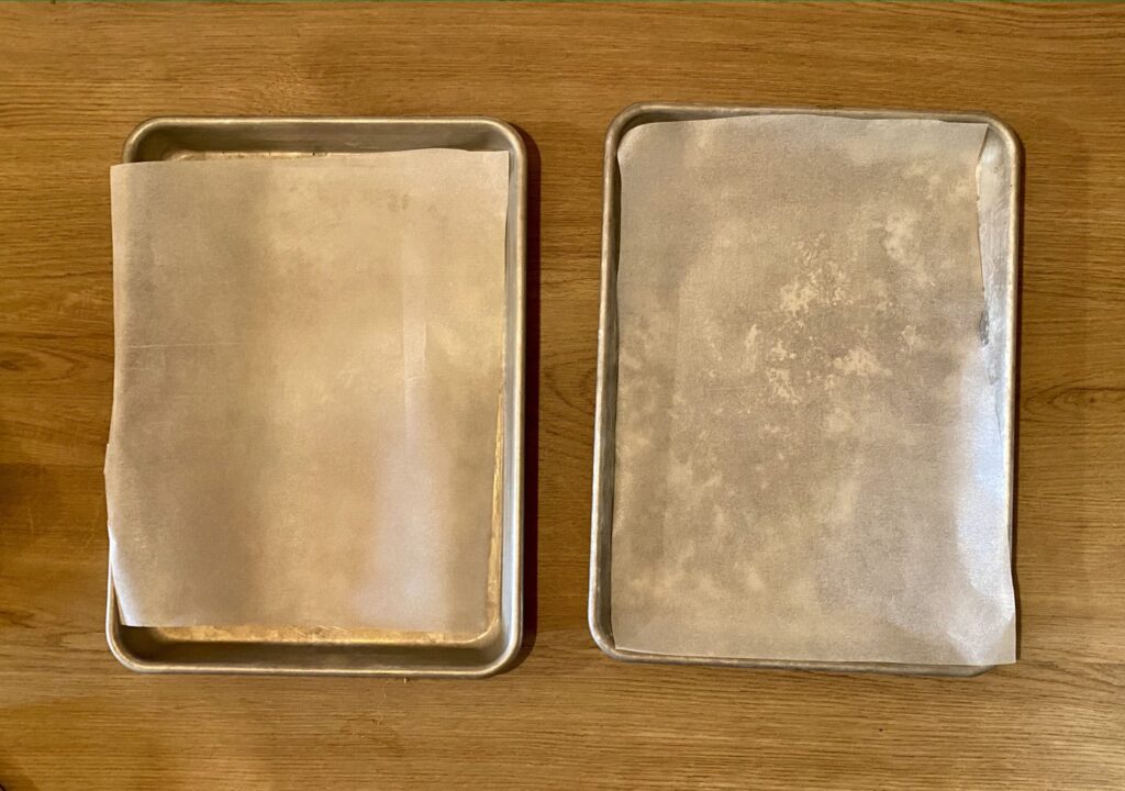 Two baking sheets lined with parchment paper