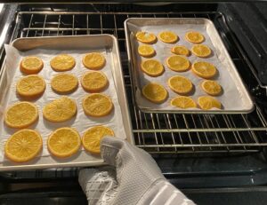 Orange slices on a baking sheet in the oven 