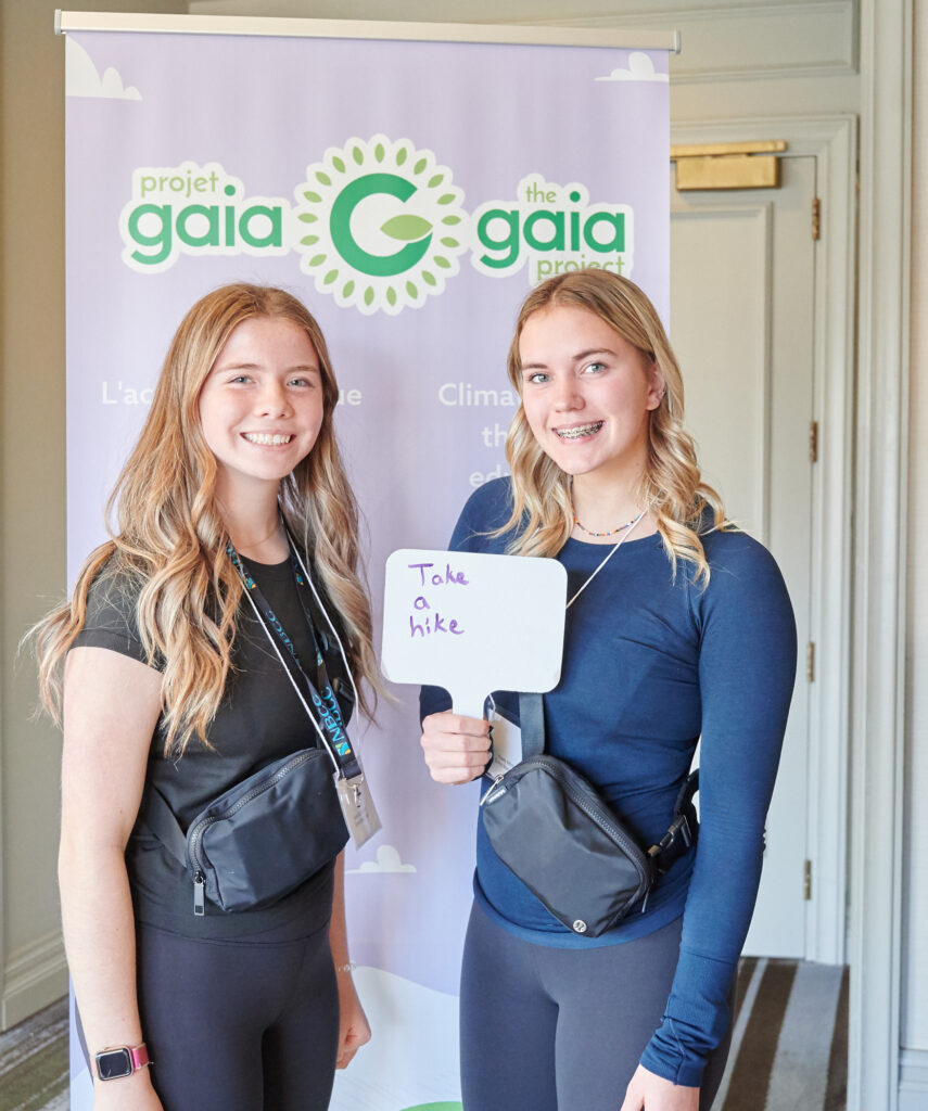 Two students attending a youth leadership event and committing to take climate action together 