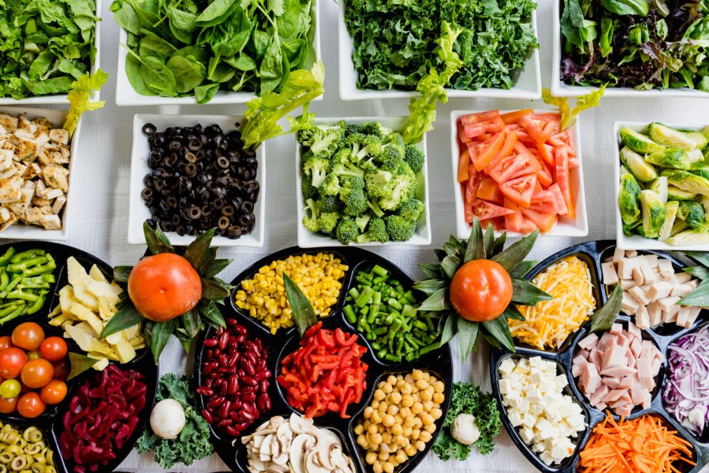 A spread of salad topping and leafy greens 