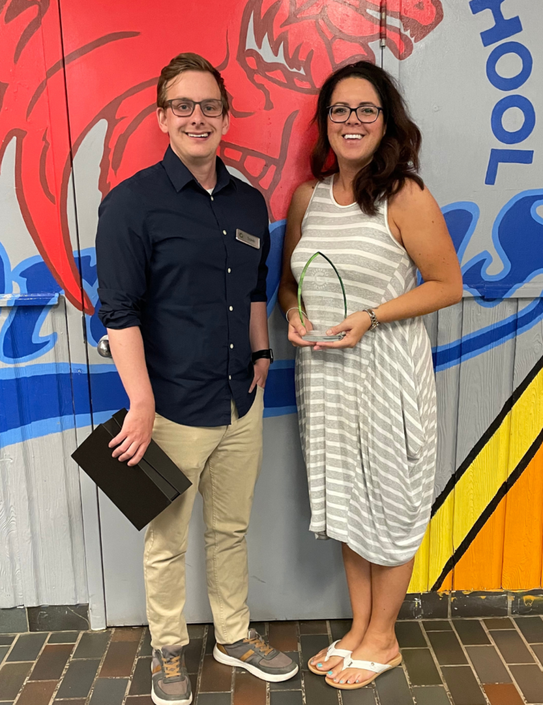 A photo of Jessica Curry accepting an award from Travis Daley of The Gaia Project 