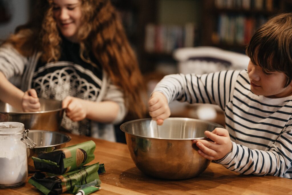 Two children with mixing bowls 
