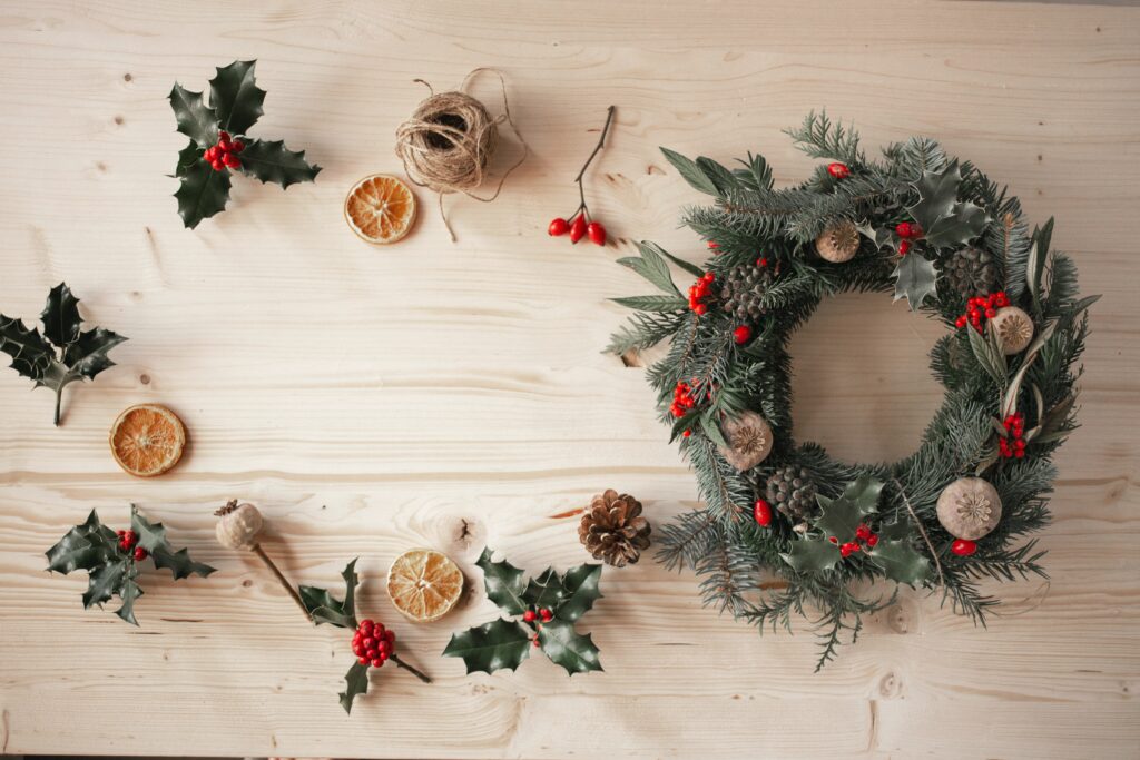 A wreath with natural decorations (foliage, dried oranges and pinecones) 