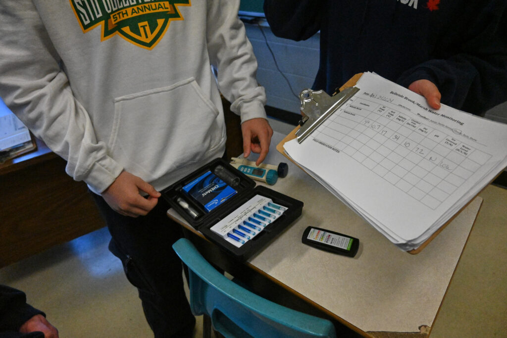 A student shows the water testing kit they received from Water Rangers 