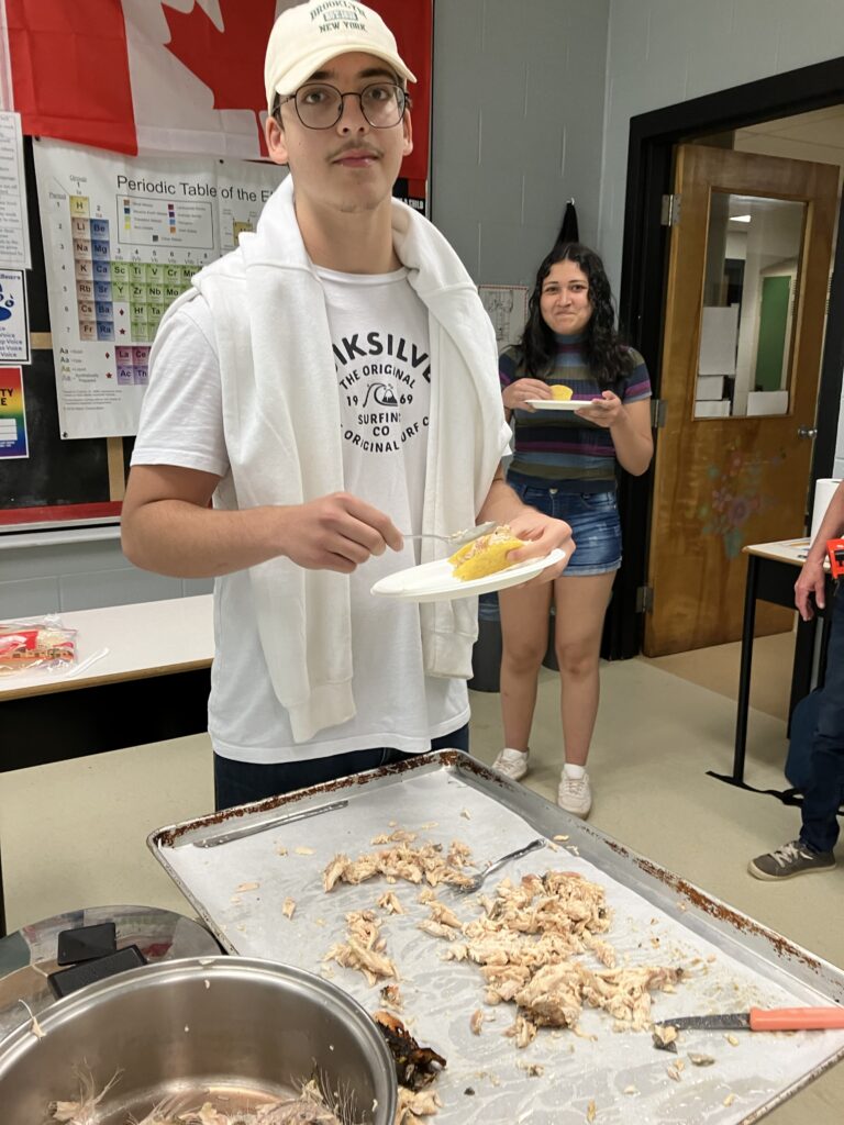 Two students eating fish tacos in their classroom 