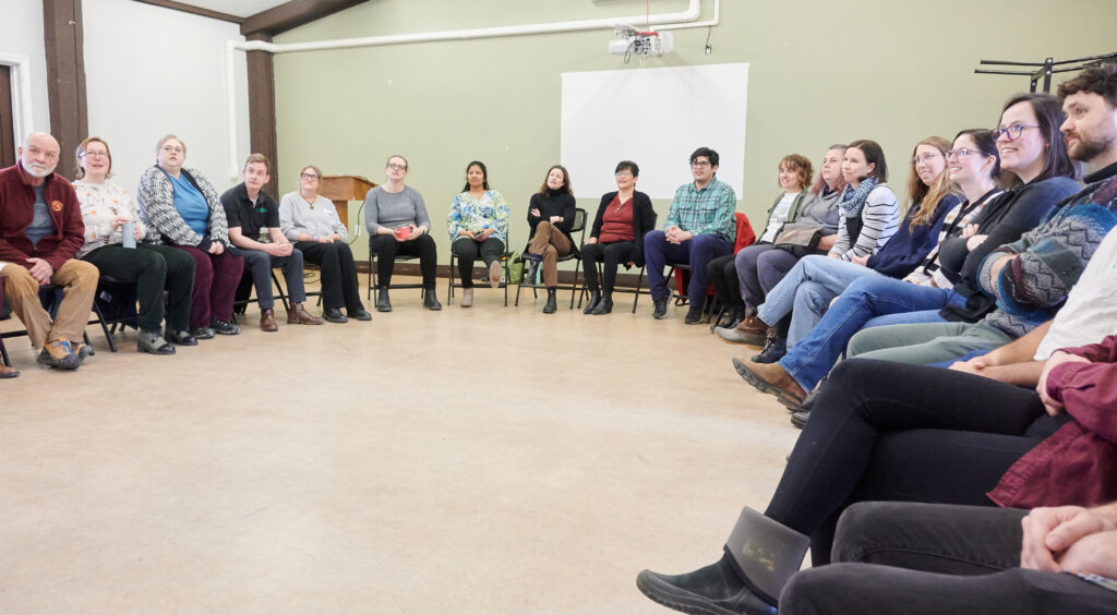 A group of professionals sitting in a circle, participating in team building. 