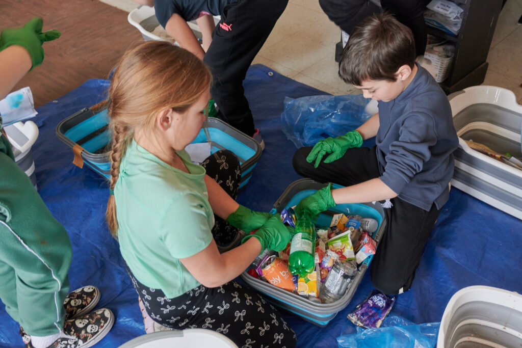 Two students sorting waste in a classroom 
